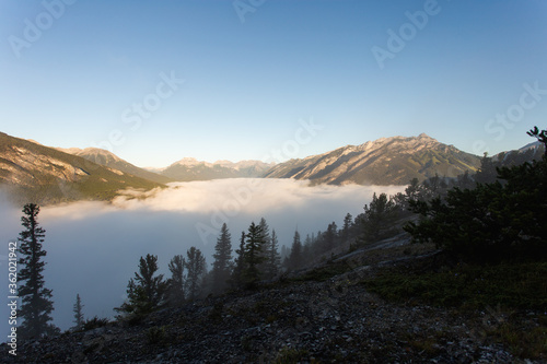 Fototapeta Naklejka Na Ścianę i Meble -  Sunrise over the mountains with a cloud below doing an inversion
