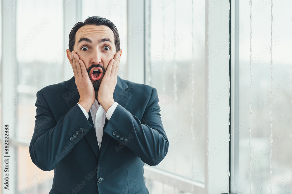 Man looking surprised, open-mouthed, shocked, keeping hands on cheeks, realizing a new thought, idea or some news. Man looking surprised, open-mouthed, shocked, keeping hands on cheeks, realizing a new thought, idea or some news.