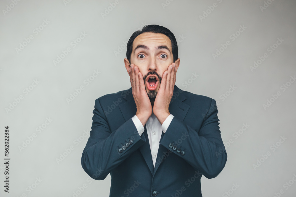 Man looking surprised, open-mouthed, shocked, keeping hands on cheeks, realizing a new thought, idea or some news. Man looking surprised, open-mouthed, shocked, keeping hands on cheeks, realizing a new thought, idea or some news.