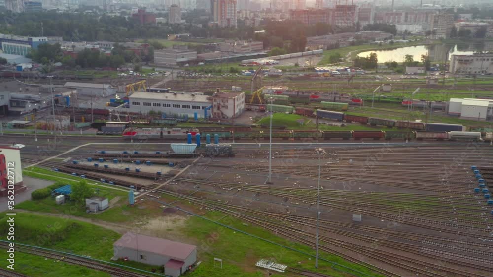 Large railway sorting station. A lot of cars, rails, buildings. View from the drone. Large railway sorting station. A lot of cars, rails, buildings. View from the drone.