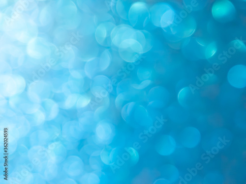 Abstract colorful blue bokeh gradient effect texture on black background. glitter modern lights defocused look luxury and elegant for Christmas or celebrate. Sparkling magical dust particles.