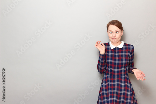 Portrait of funny confused perplexed girl making silly goofy faces