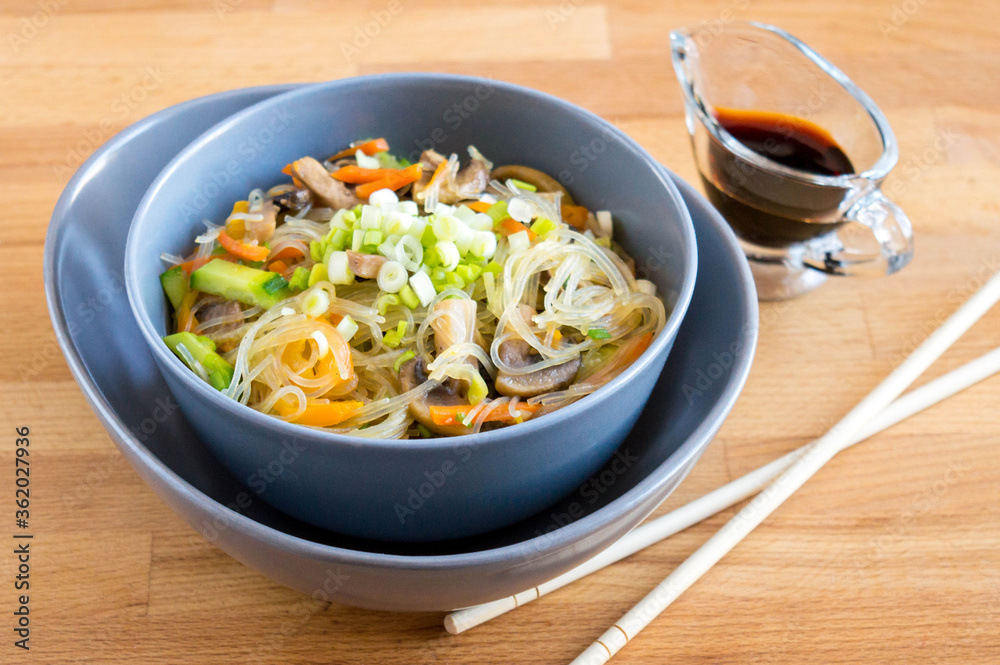 Funchosa with mushrooms, carrots, onions and peppers. Serving dishes with soy sauce Funchosa with mushrooms, carrots, onions and peppers. Serving dishes with soy sauce