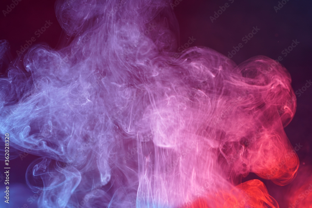 Multi colored smoke from an incense stick with color foils Photographed in front of the flash in the studio Multi colored smoke from an incense stick with color foils Photographed in front of the flash in the studio