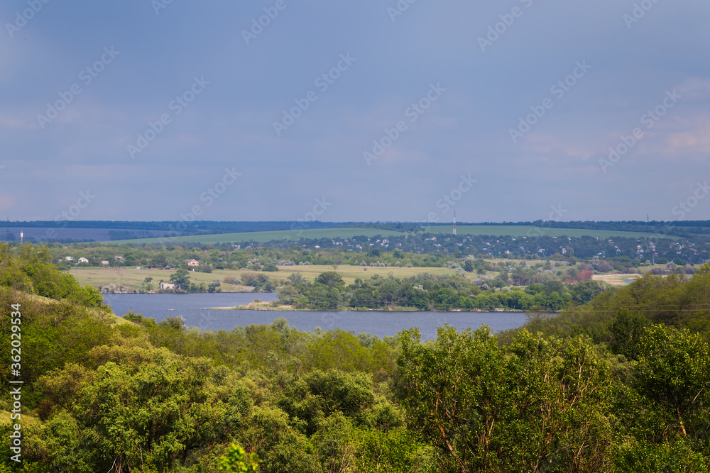 view from a forest to a lake, outdoor countryside scene