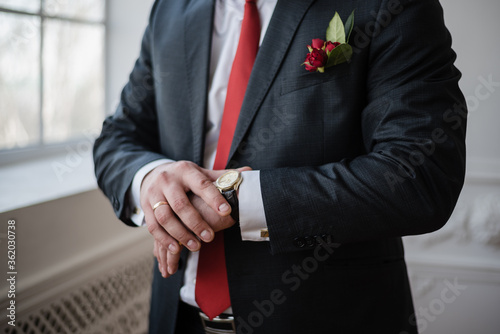 man watches time, Wrist Watch, groom in a suit, wedding day, Red tie, groom's fees
