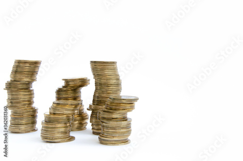 Golden coins stacked on top of each other, stacks of coins on a white background