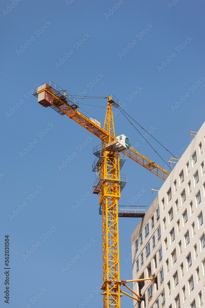 Construction site with crane against the blue sky Construction site with crane against the blue sky