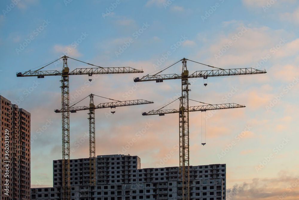 Construction site with cranes against the cloudy sky
Construction site with cranes against the cloudy sky
