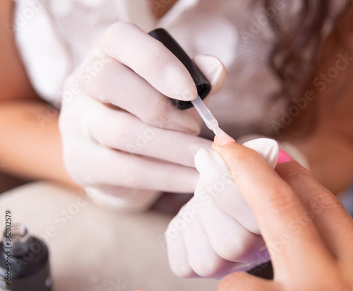 woman applying nail polish.beauty salon