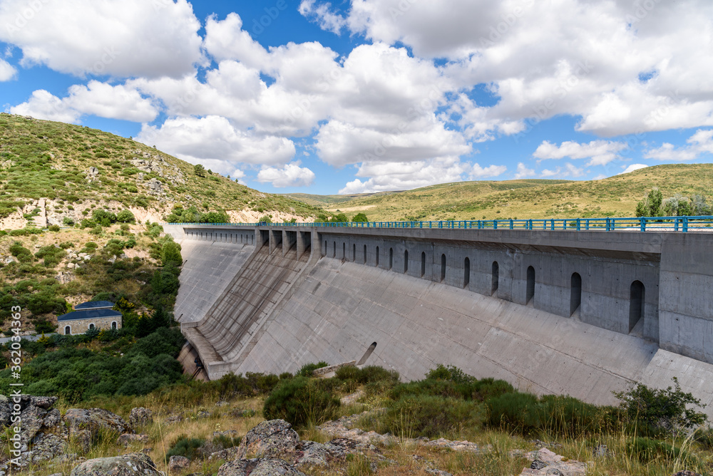 Reservoir dam a sunny day of summer. Las Navas del Marques, Avila, Spain. Reservoir dam a sunny day of summer. Las Navas del Marques, Avila, Spain.