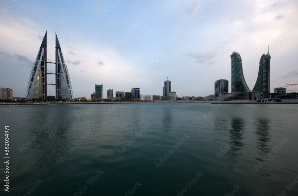 Naklejka premium MANAMA, BAHRAIN - OCTOBER 28: Bahrain skyline with iconic buildings, the Bahrain World Trade Center and the Financial Harbour during dusk on October 28, 2018, Manama, Bahrain