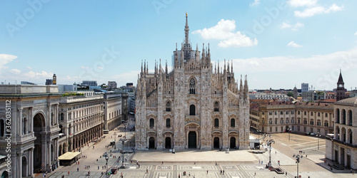 Italy, Milan July 2020 - Drone aerial view of Duomo Cathedral after finish of lockdown due COVID-19 Coronavirus outbreak, people outside with mask and tourist in downtown and Vittorio Emanuele Gallery