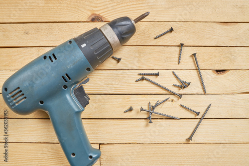 diy wood working at home. wooden planks with screwdriver. woodwork. domestic life. male person repair or fixing furniture.