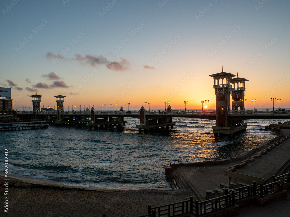 the famous architectural masterpiece of the stanley bridge and beach in Alexandria at sunset