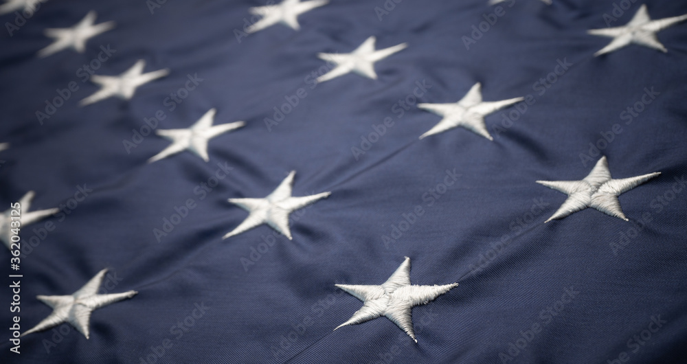 Fototapeta premium White American stars on blue usa flag. Close up shot.