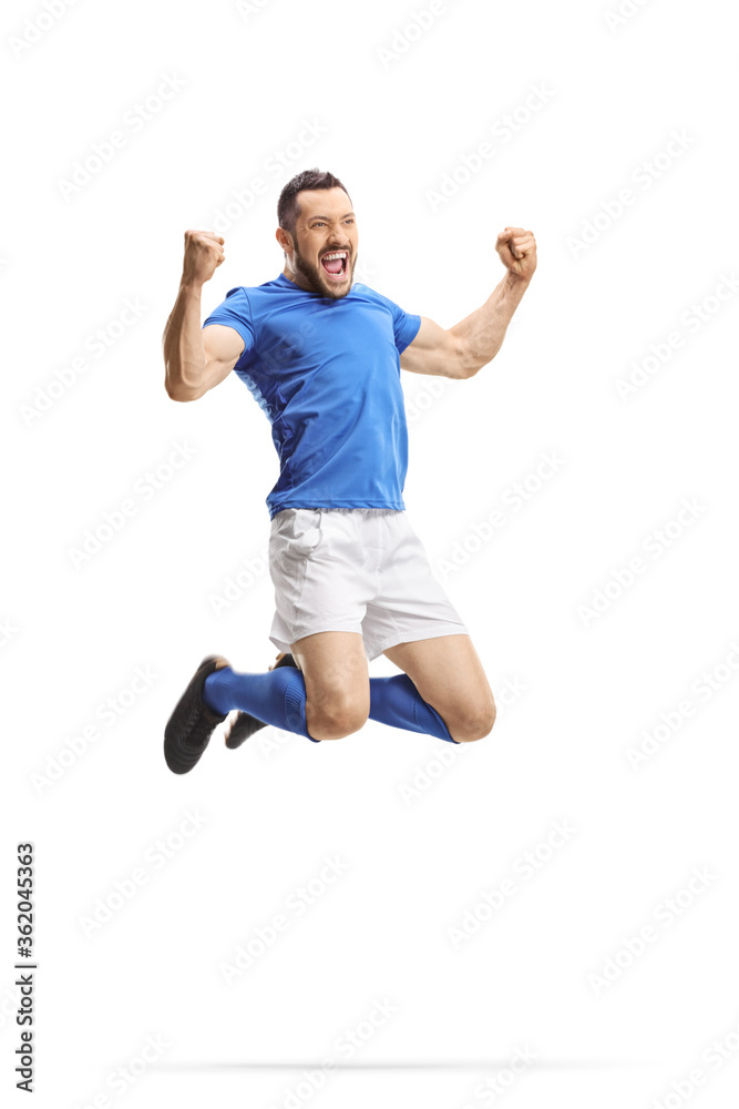 Happy footballer jumping and celebrating a goal