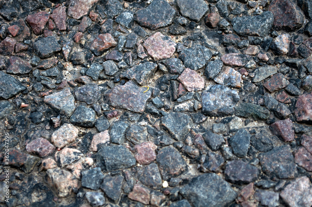 grained asphalt, from under which stones can be seen grained asphalt, from under which stones can be seen