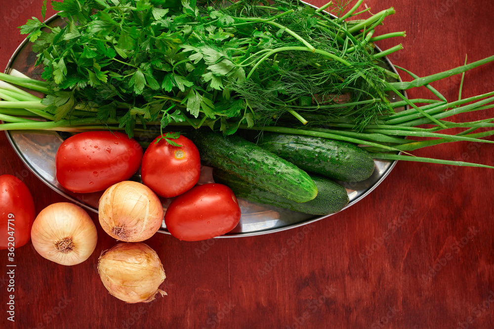 healthy food - fresh vegetables and greens on a wooden background, greens, onion and tomatoes healthy food - fresh vegetables and greens on a wooden background, greens, onion and tomatoes
