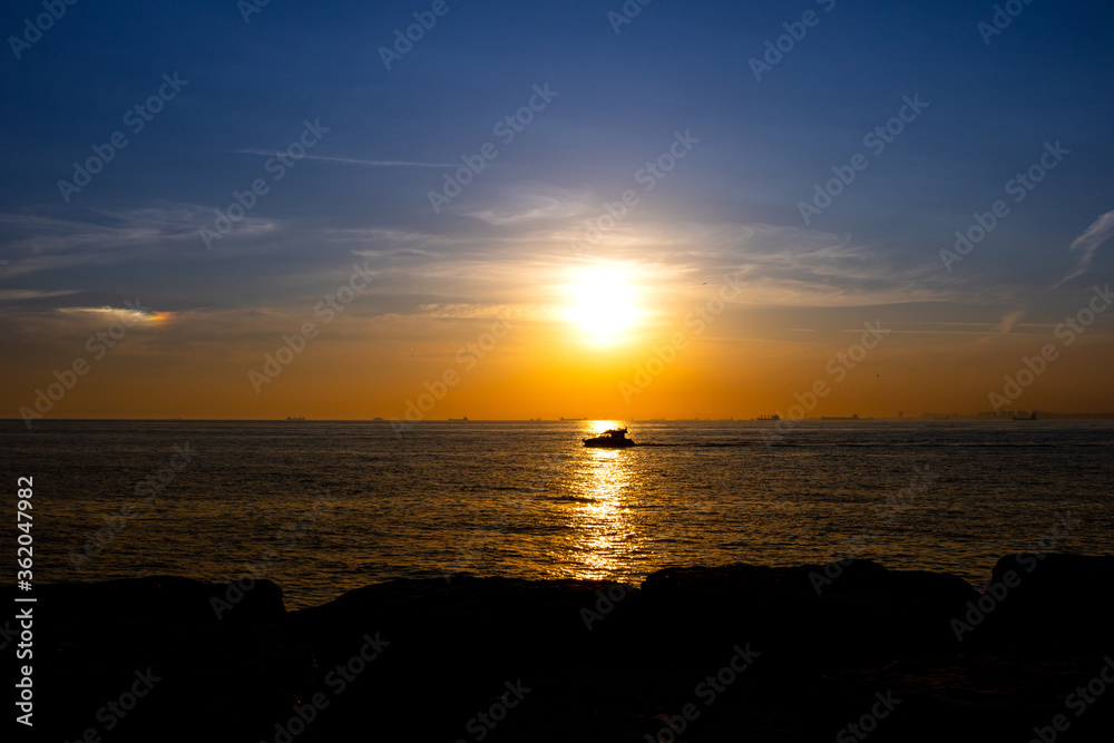 Sunset over the sea and a boat