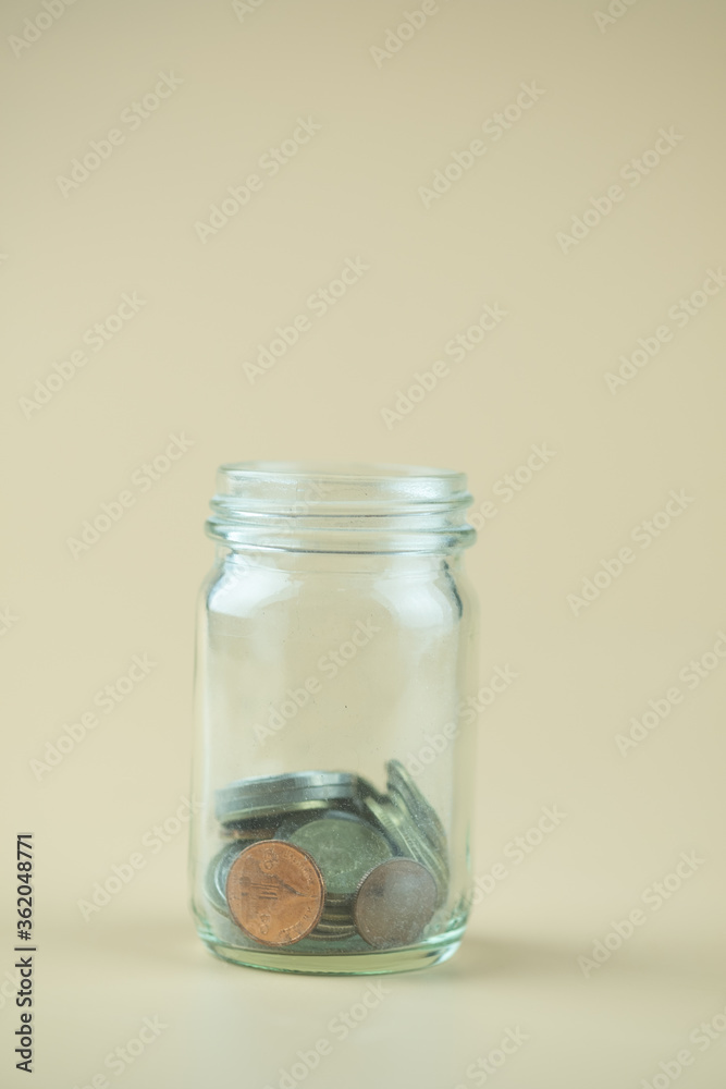 Close up of Thai coins in glass jar. Close up of Thai coins in glass jar.