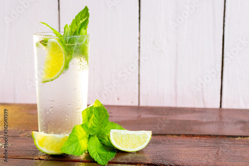 A glass of fresh Mojito. Lime and mint. On a wooden background