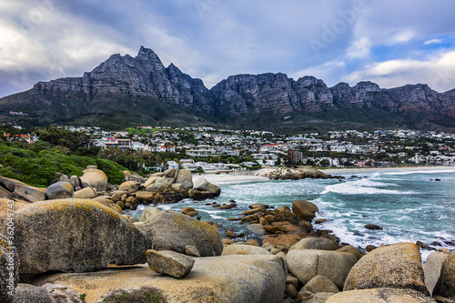 Wonderful Camps Bay nature (Kampsbaai) before sunset - affluent suburb of Cape Town. Camps Bay bordered by spectacular Twelve Apostles Mountain and glittering Atlantic Ocean. Camps Bay, South Africa.