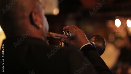 Canvas Print man playing trumpet from back
