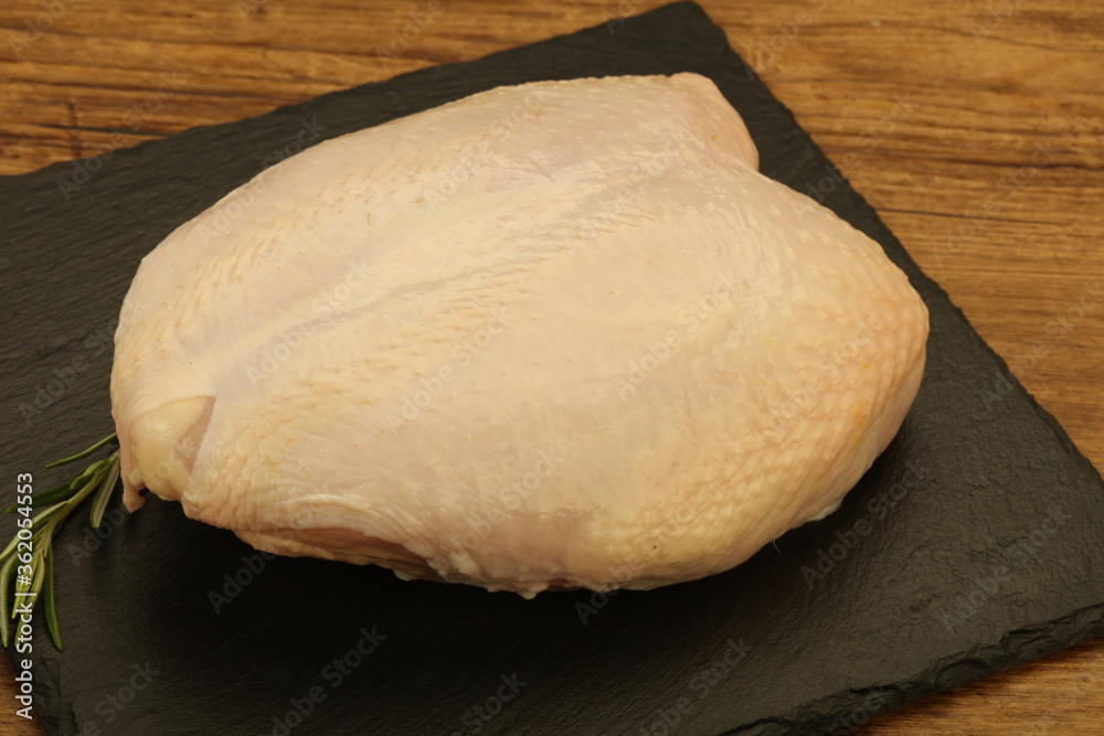 Raw whole chicken breast with skin Raw whole chicken breast with skin