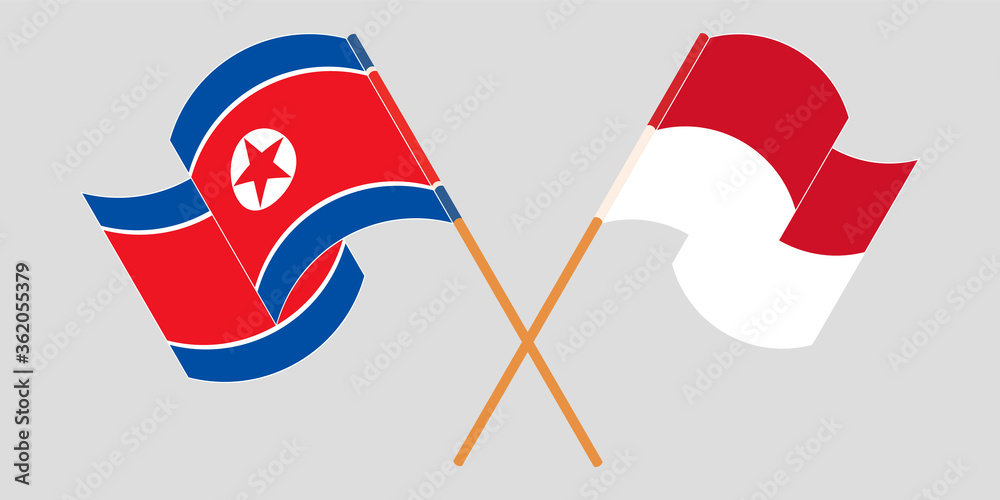 Crossed and waving flags of North Korea and Indonesia Crossed and waving flags of North Korea and Indonesia