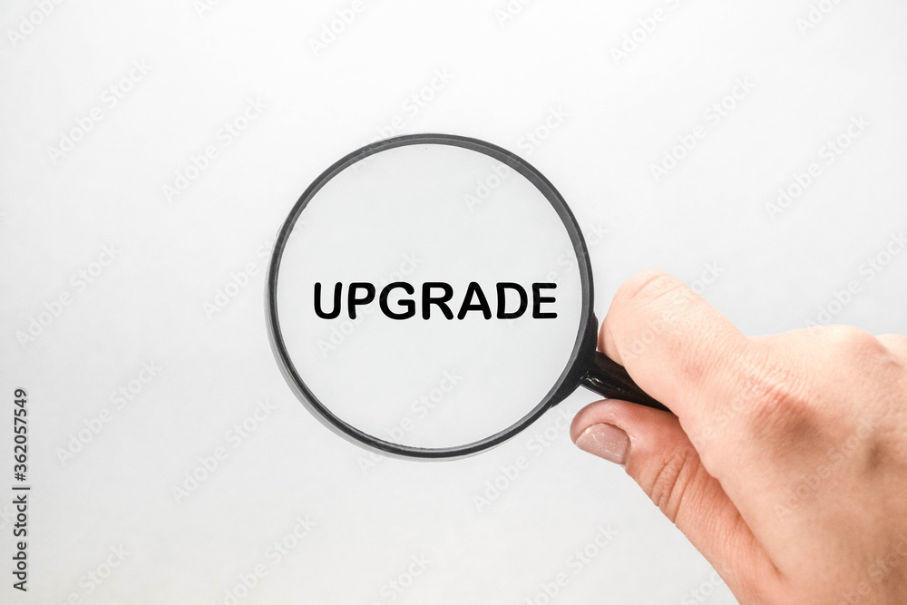 Update text written through a magnifying glass on a white background. Business concept Update text written through a magnifying glass on a white background. Business concept