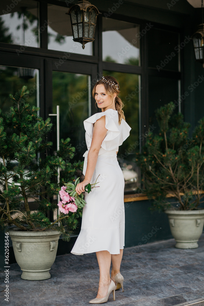 Young beautiful lady in white dress looking at camera. Young beautiful lady in white dress looking at camera.