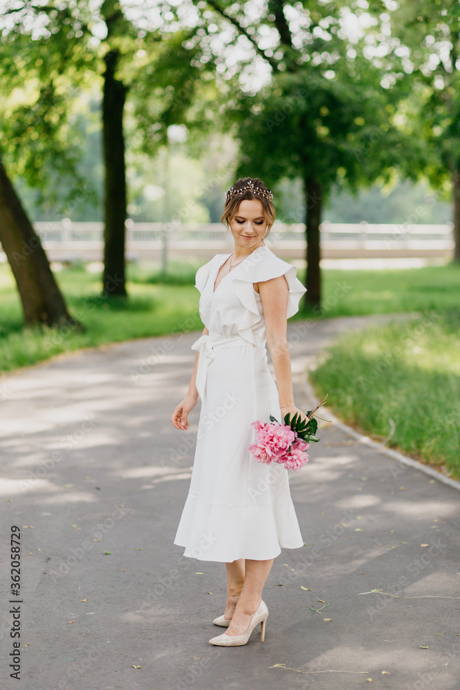 Young beautiful lady in white dress, with the bouquet of peonies. Young beautiful lady in white dress, with the bouquet of peonies.