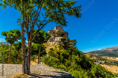 A tree lined path zigzags up to the Church of Saint Maria in the hilltop village of Petralia Soprana in the Madonie Mountains, Sicily during summer photo