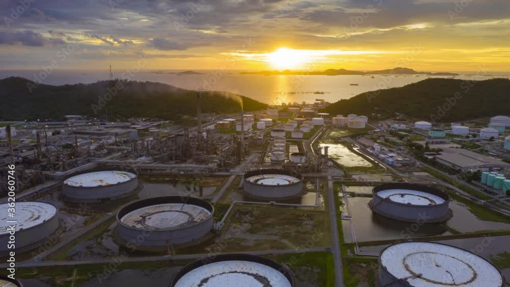 4K UHD resolution drone Hyperlapse of oil refinery plant chemical factory and power plant with many storage tanks and pipelines at sunset.