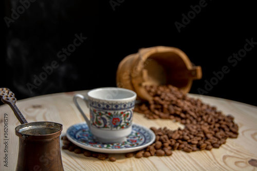 coffee cup, coffee grains on wooden table