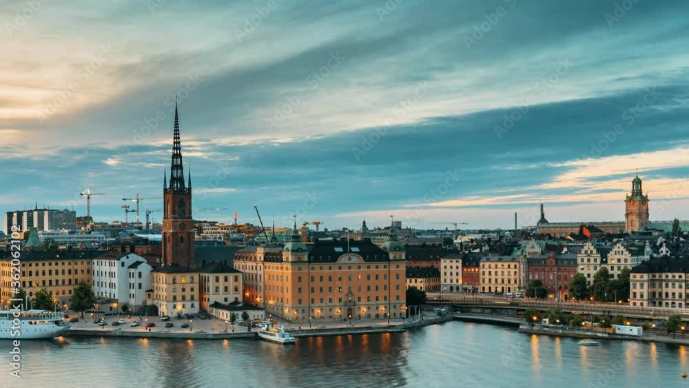 Stockholm, Sweden. Scenic View Of Stockholm Skyline At Summer Evening. Famous Popular Destination Scenic Place In Dusk Lights. Riddarholm Church In Day To Night Transition Time Lapse Stockholm, Sweden. Scenic View Of Stockholm Skyline At Summer Evening. Famous Popular Destination Scenic Place In Dusk Lights. Riddarholm Church In Day To Night Transition Time Lapse