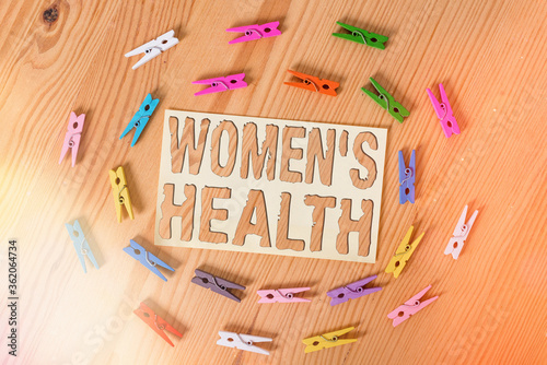 Text sign showing Womens Health. Business photo showcasing treatment and diagnosis of diseases related to health Colored clothespin papers empty reminder wooden floor background office photo