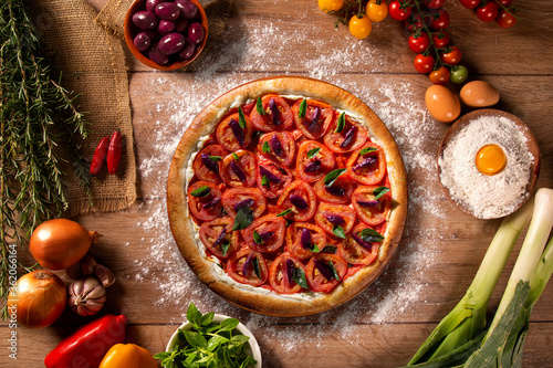Fototapeta Naklejka Na Ścianę i Meble -  Pizza with tomato, olive and basil. Top view on wood background, close up. Traditional Brazilian Pizza