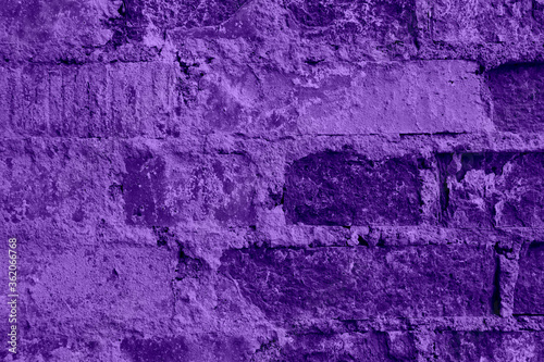 Closeup shot of wall of old purple bricks with crack cement