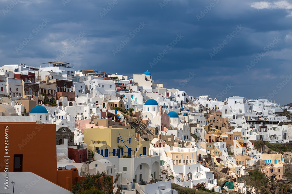 View of Oia city at sunrise. City on Santorini island in Greece.