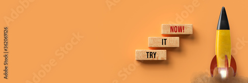 starting colorful rocket and cubes with message TRY IT NOW on orange background