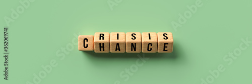 flipping cubes showing both words CRISIS and CHANCE at the same time on colorful background photo