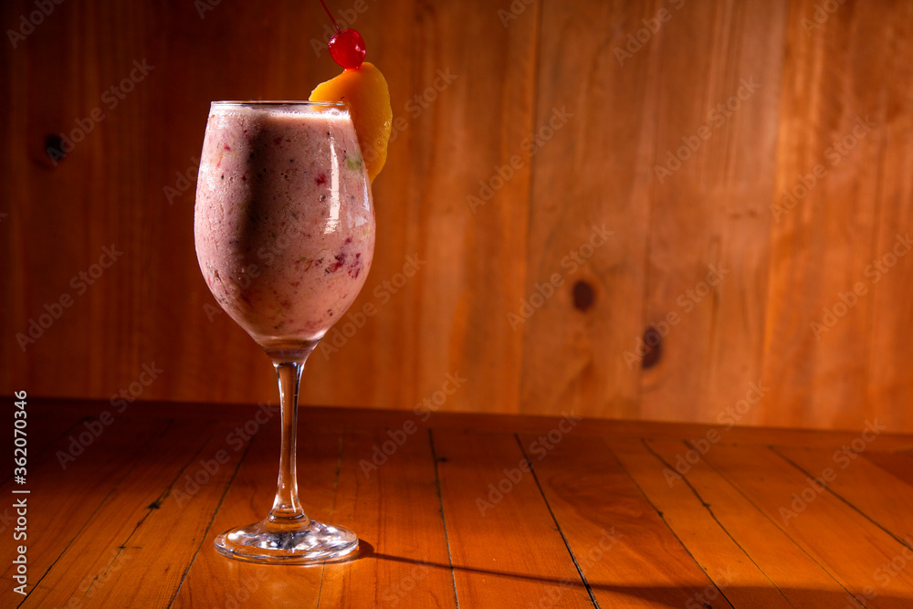 Fotografie Fruit cocktail on wood background.