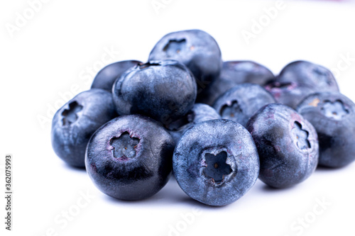 Blueberry macro image. Fresh sweet and ripe blueberry close up on white isolated background. Selective focused.