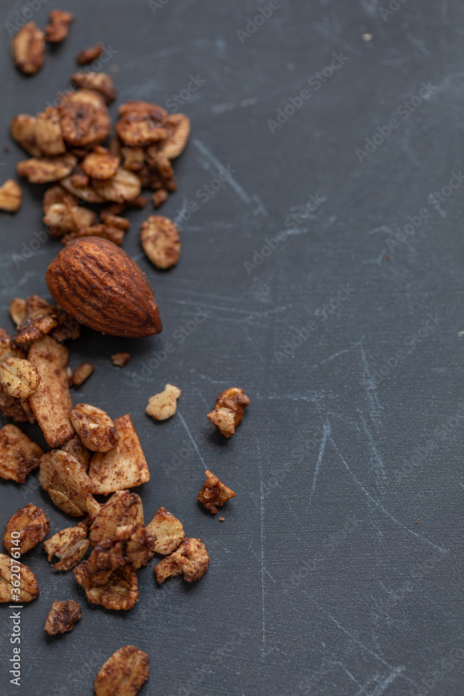Obraz premium Nuts and granola on a dark grey background