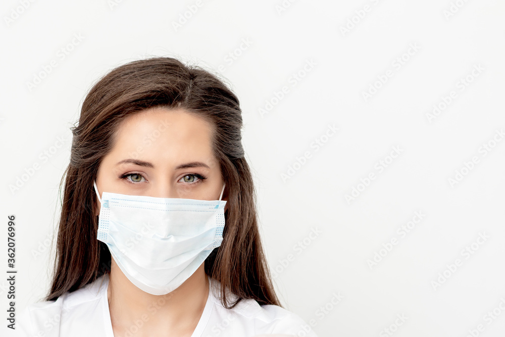 Portrait of young caucasian woman with medical mask on white background. Coronavirus concept Portrait of young caucasian woman with medical mask on white background. Coronavirus concept
