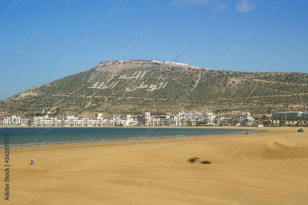 beach of Agadir Morocco, name of the mountain Oufellah, inscription: God, country, king