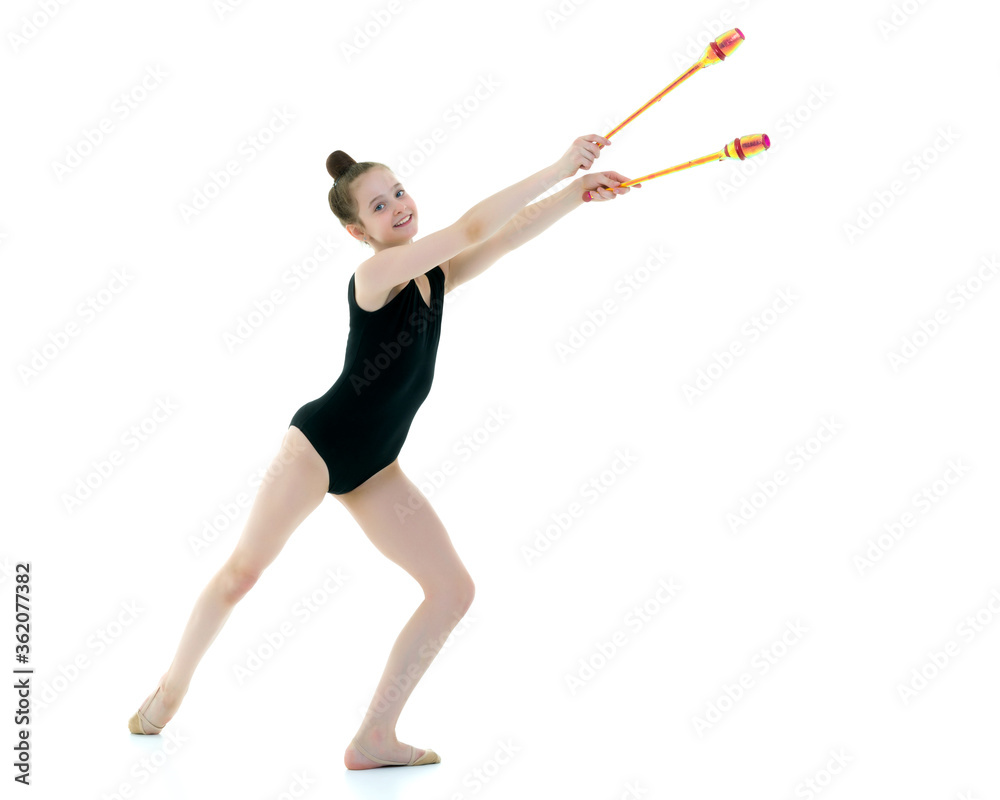 A girl gymnast performs exercises with a mace. A girl gymnast performs exercises with a mace.