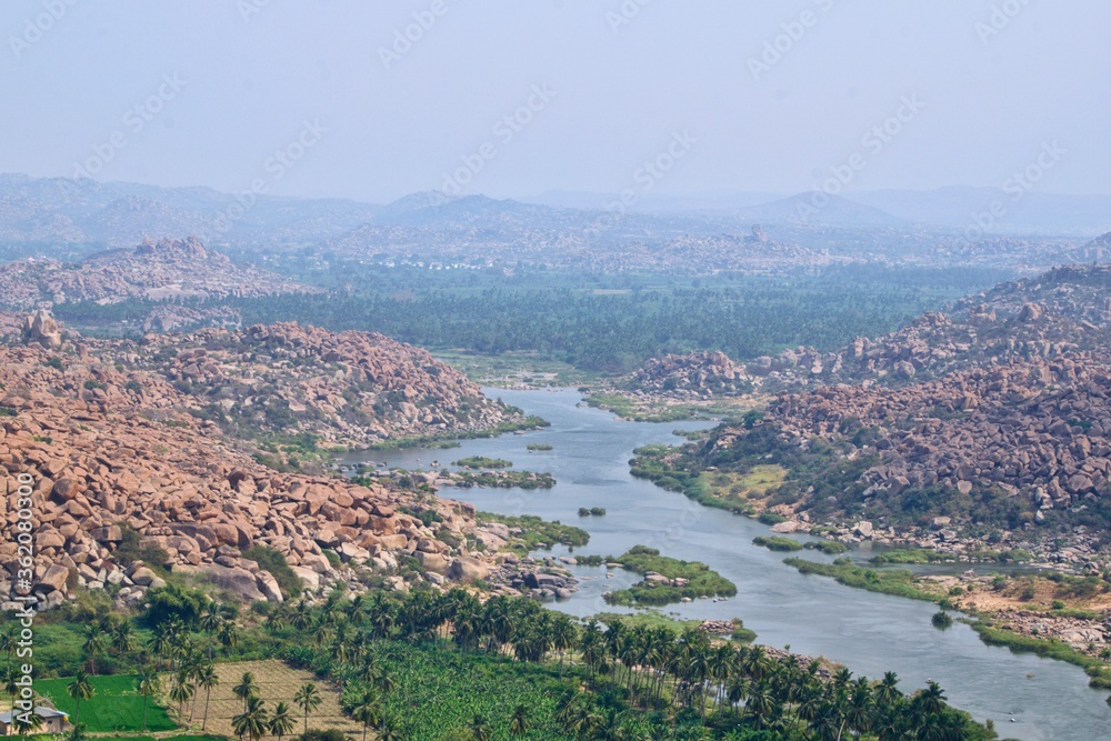 View of Tungabhadra river from Anjaneya hill flowing in between ween the boulders.